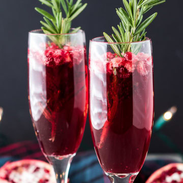 Two festive mimosas with garnishes.