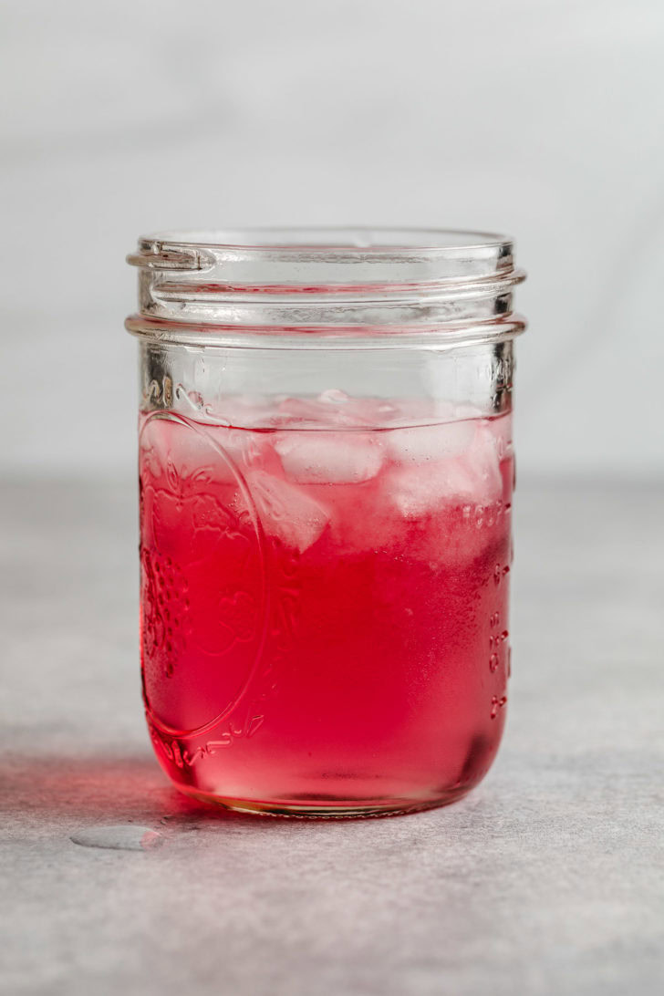 Festive Vodka Cranberry Cocktail Vodka cranberry cocktail in a glass jar.