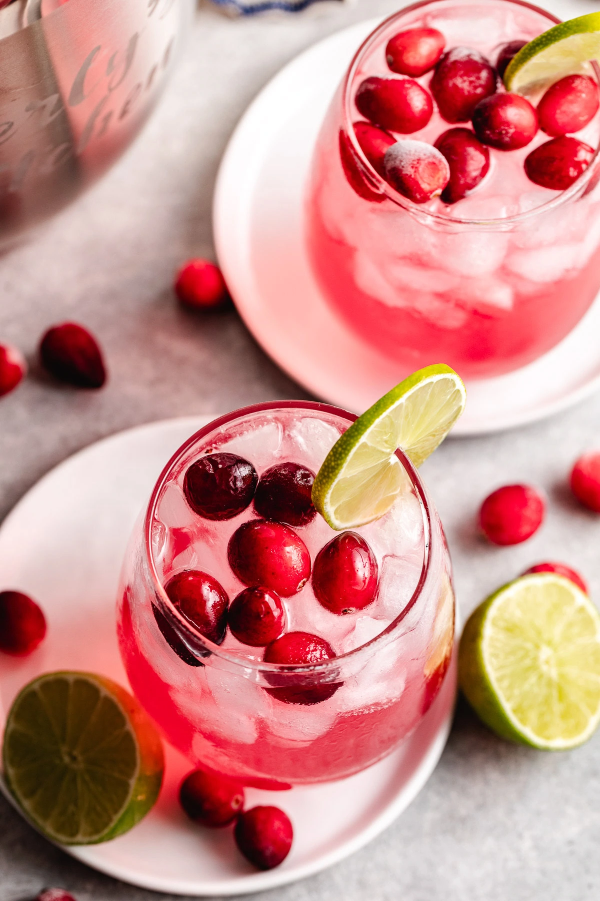 Cranberry drinks with lime garnish.