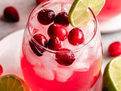 Vodka cranberry cocktail with lime and berries.