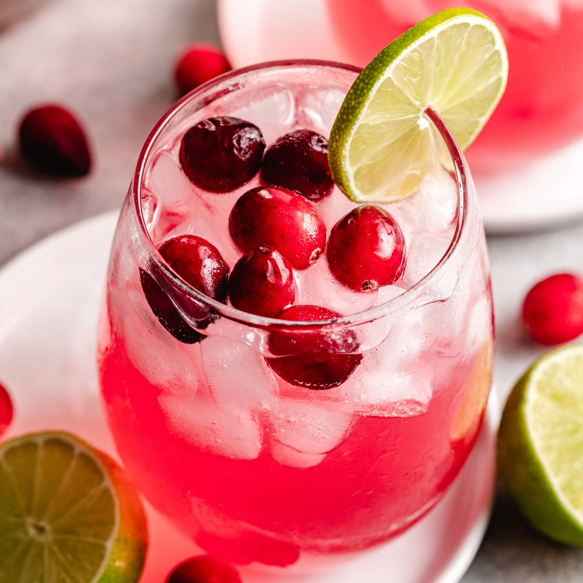 Vodka cranberry cocktail with lime and berries.