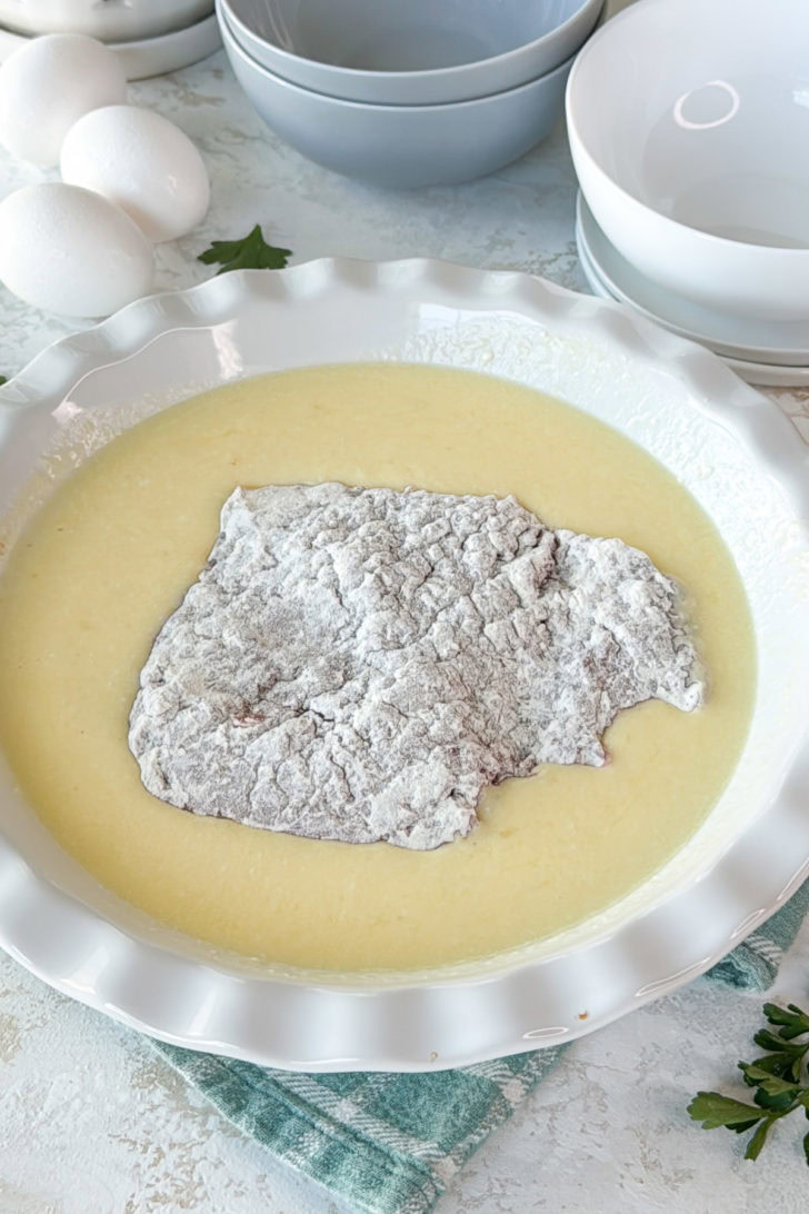 Floured cube steak dipped in an egg and buttermilk mixture.