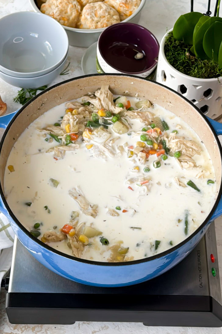 Heavy cream poured into chicken soup.