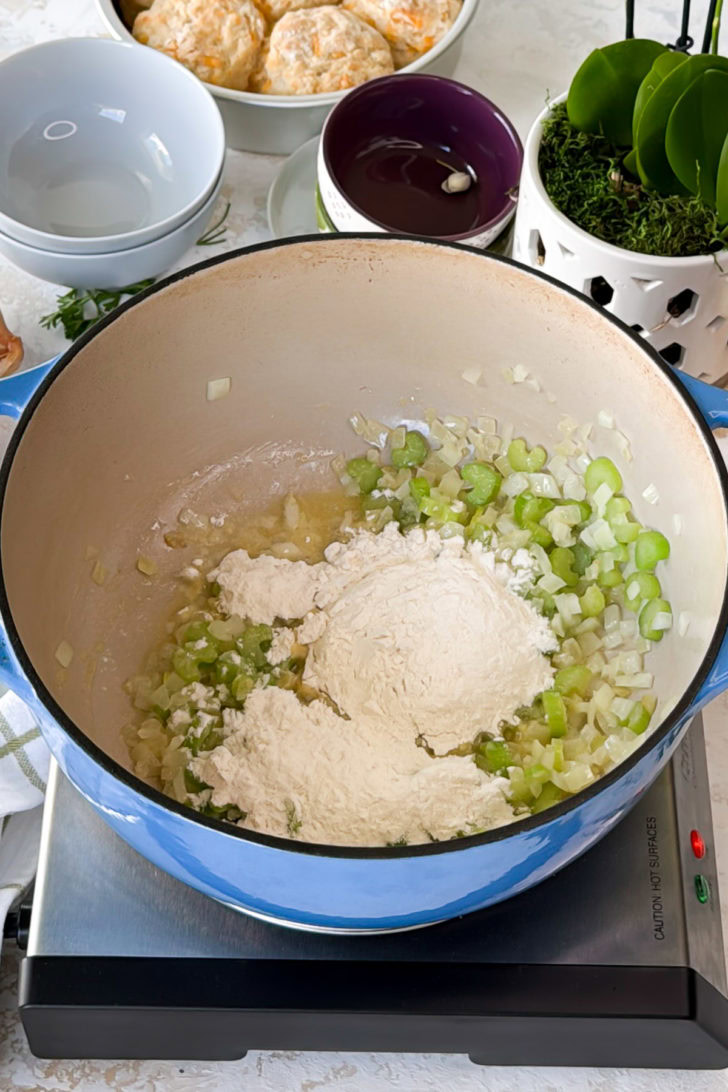 Flour sprinkled over butter, onions, and celery.