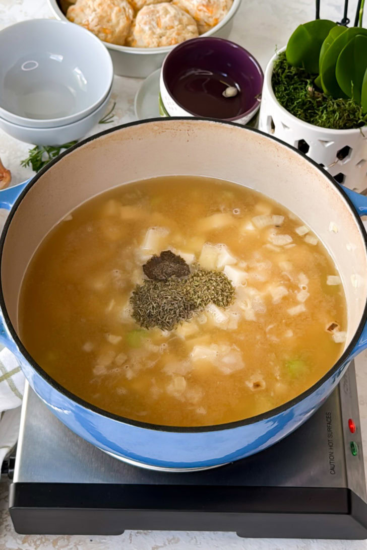 Seasonings added to broth and potatoes.