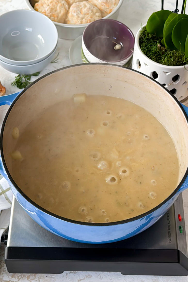 Broth and seasonings stirred into potatoes.