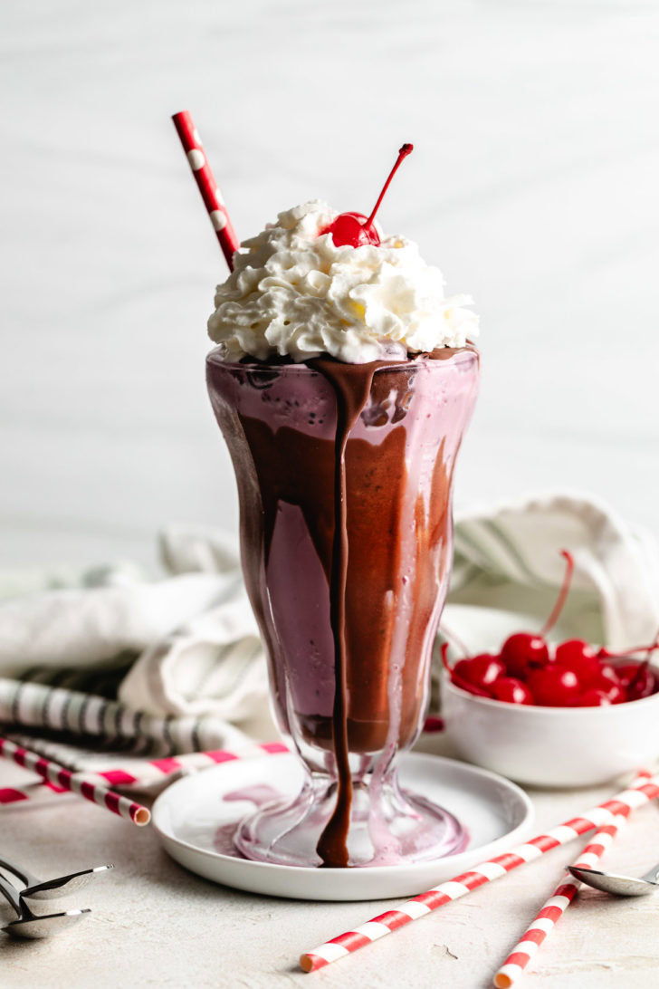 Milkshake with chocolate, whipped cream and a cherry.