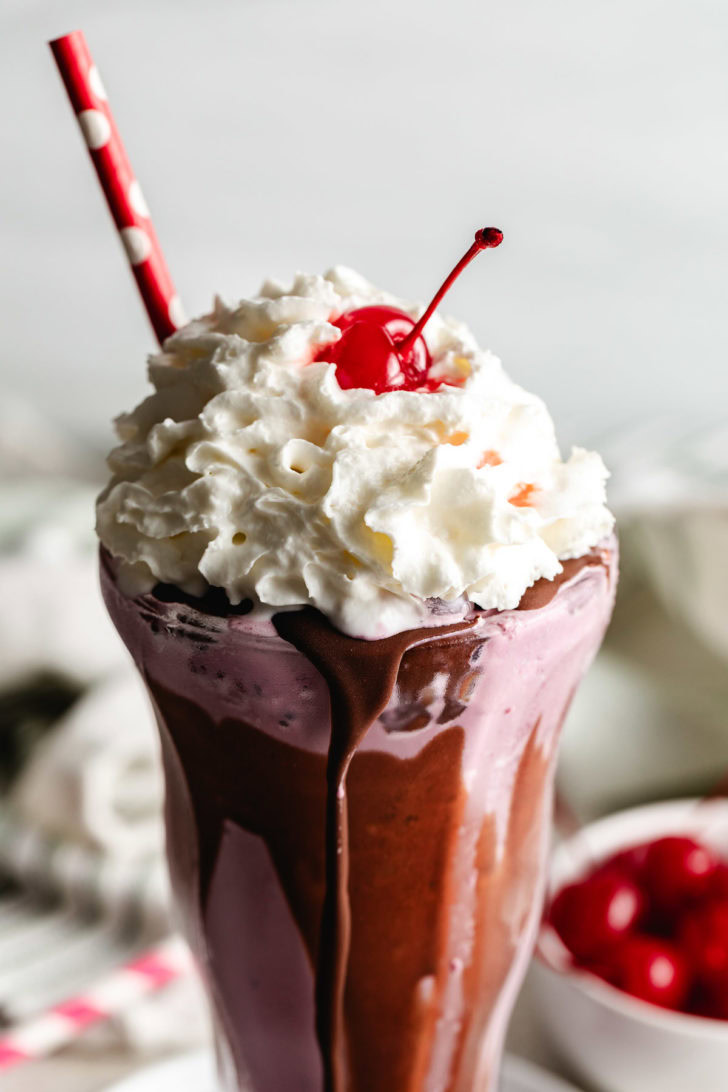 Cherry milkshake topped with whipped cream.