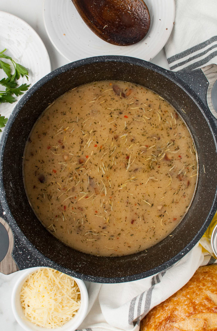Creamy Chicken And Wild Rice Soup Seasoned broth and vegetables in a pot.