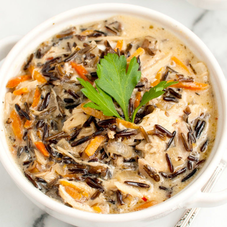 Close up view of creamy chicken and wild rice soup in a bowl.