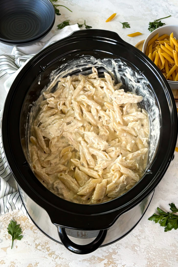 Crockpot Italian chicken pasta mixed in the slow cooker.