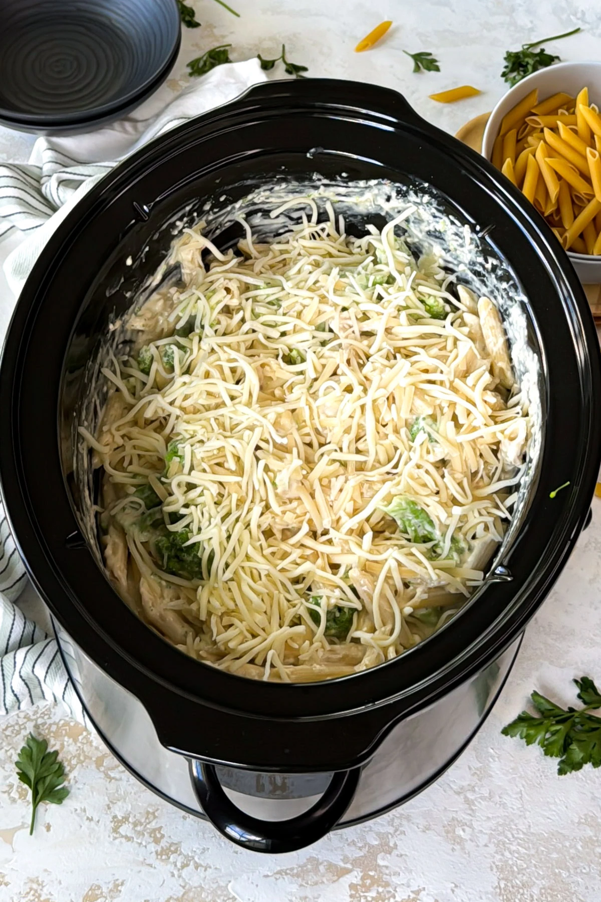 Shredded mozzarella scattered over creamy chicken pasta.