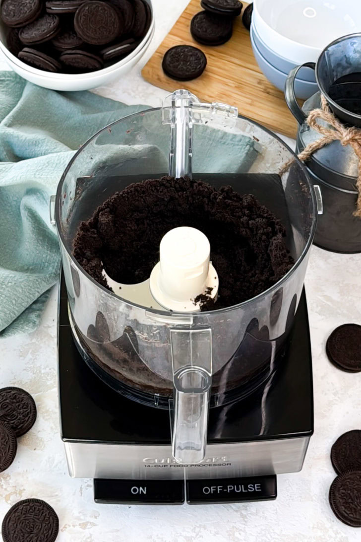 Oreo crumbs and melted butter combined in a food processor.
