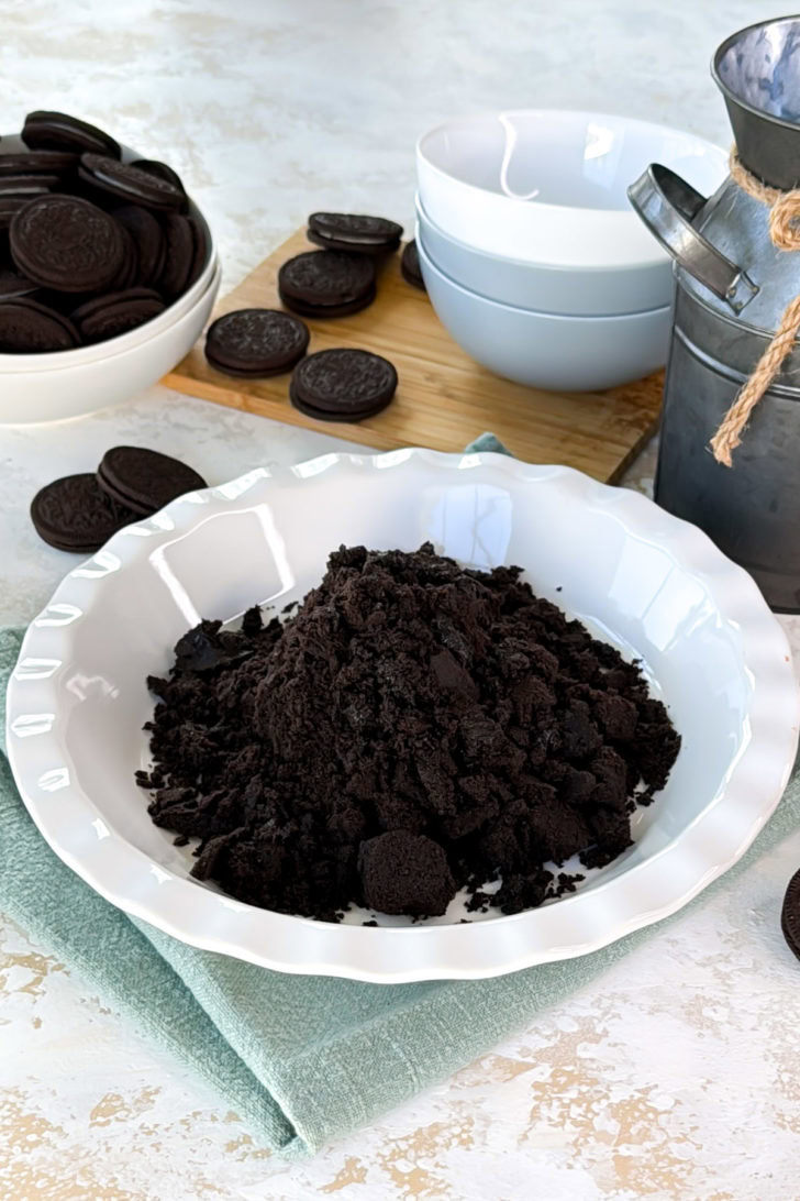 Oreo crumbs poured into a pie dish.