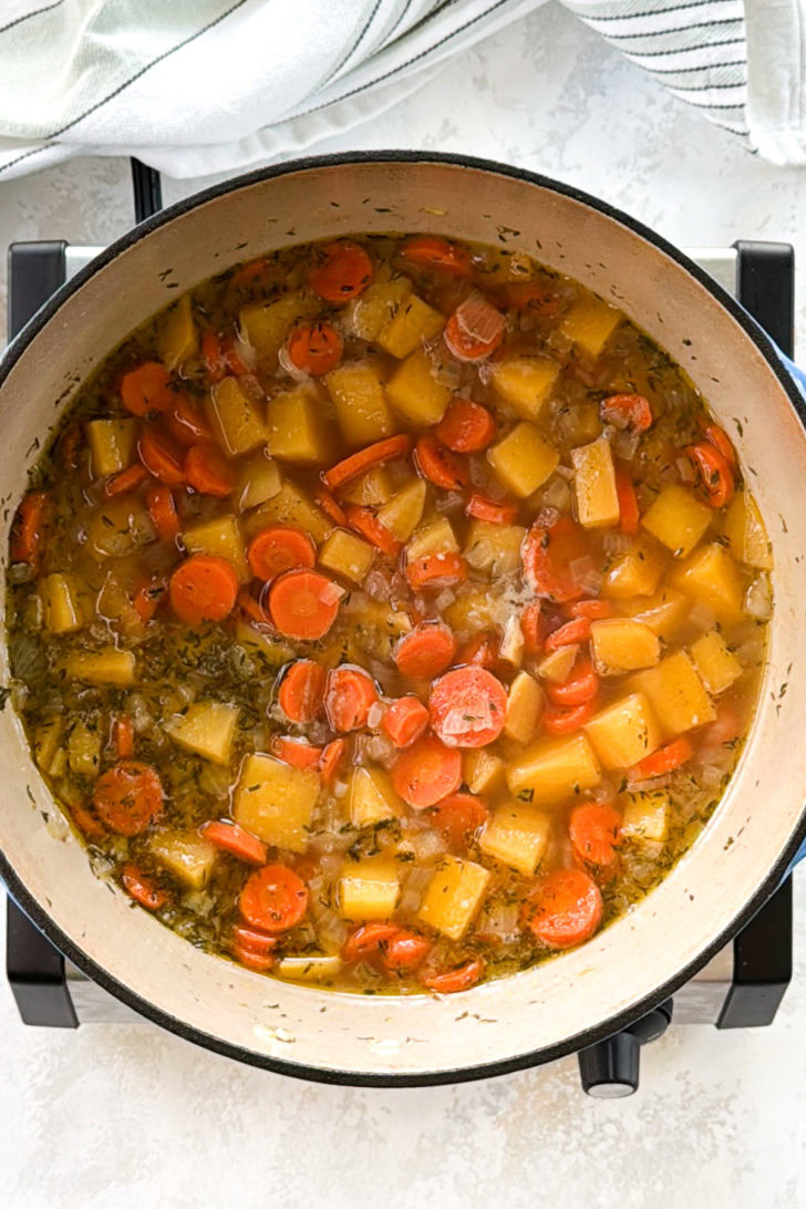 Boiled root vegetables in a pan.