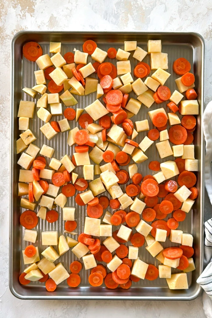 Chopped vegetables on a baking sheet.