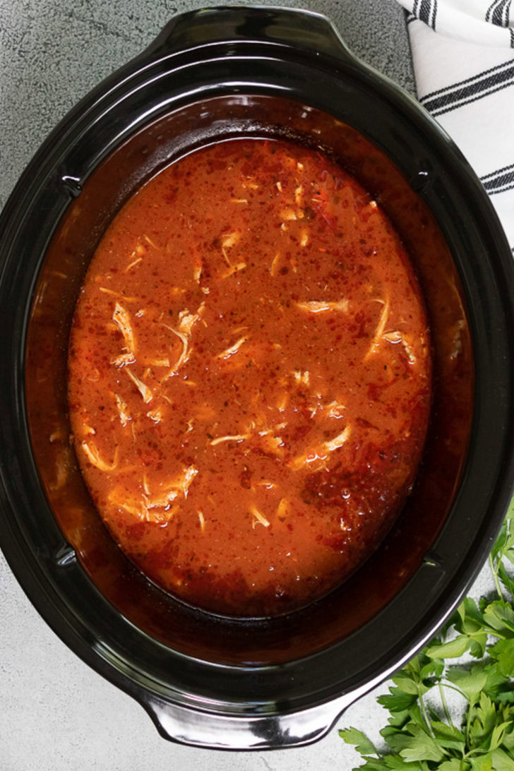 Shredded chicken in marinara in a slow cooker.