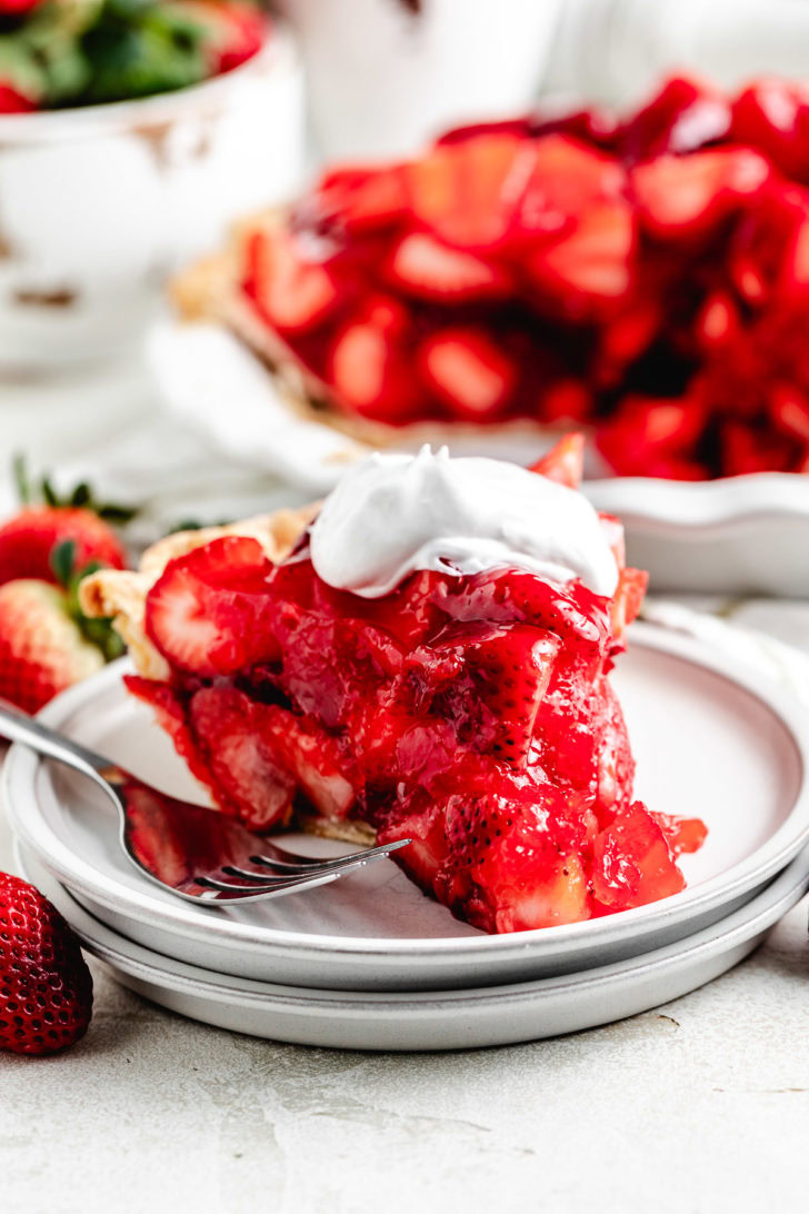 Fresh strawberry pie topped with glossy sliced berries.