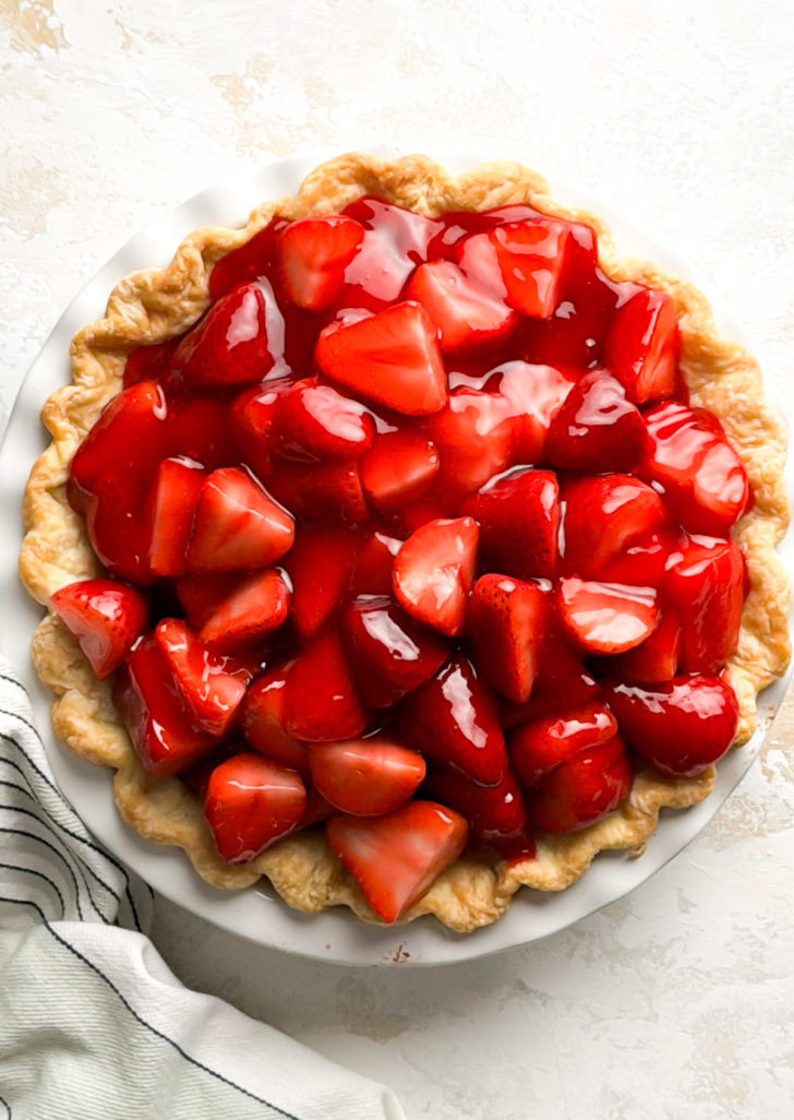 Overhead view of fresh strawberry pie in a flaky crust.