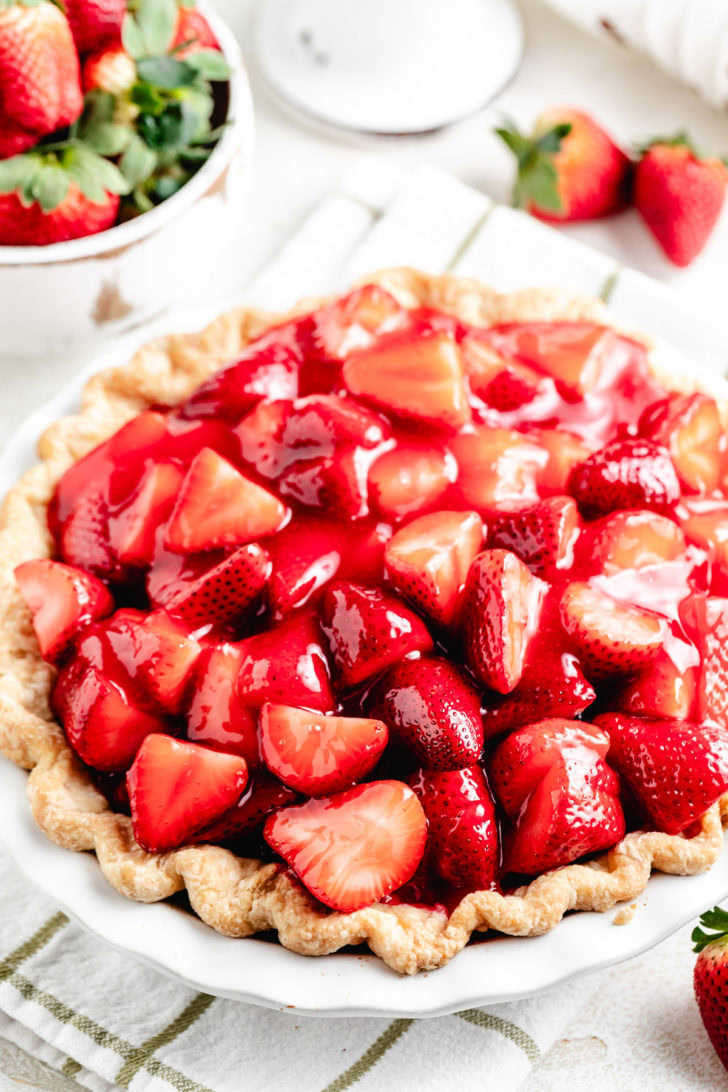 Close-up of glazed strawberries piled in a baked crust.