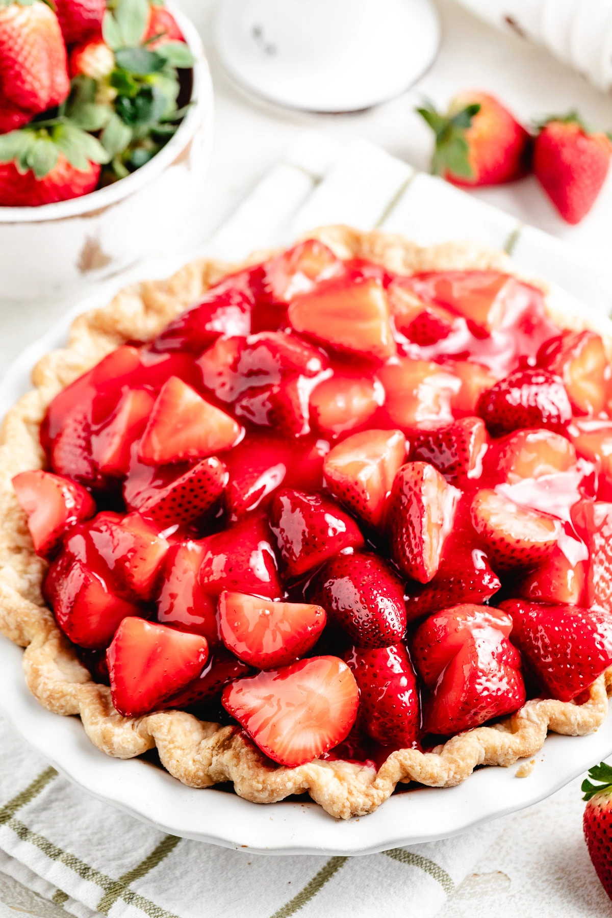 Close-up of glazed strawberries piled in a baked crust.