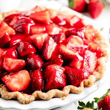 Fresh strawberry pie topped with glossy sliced berries.