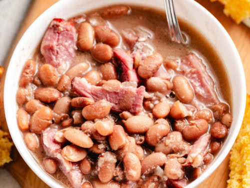Close-up bowl of ham and beans recipe with cornbread.