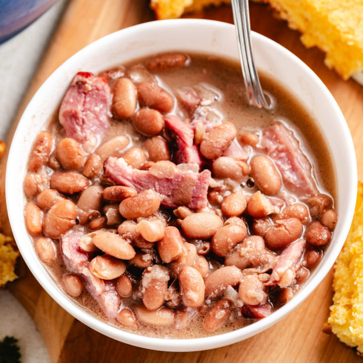 Close-up bowl of ham and beans recipe with cornbread.