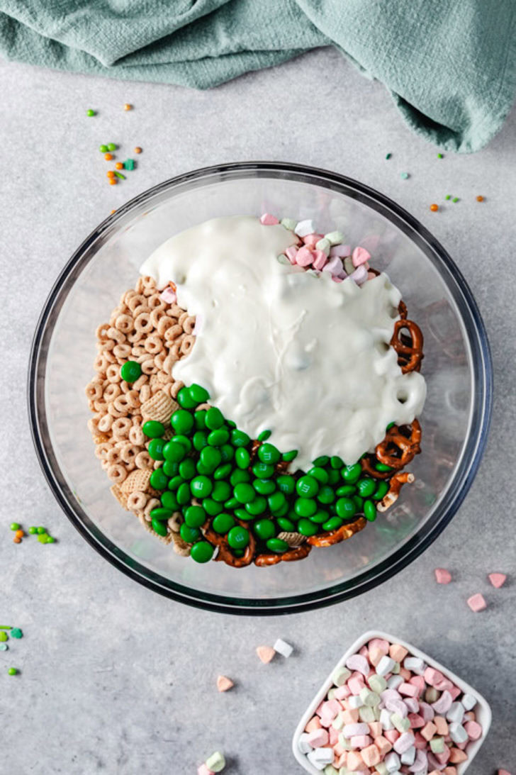 Melted white candy coating poured over leprechaun bait ingredients.