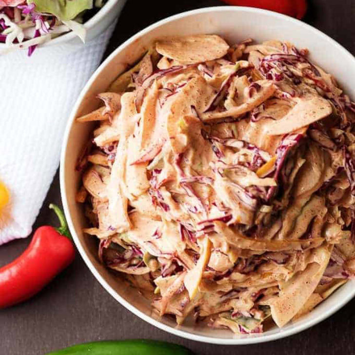 Overhead view of spicy coleslaw in a bowl.