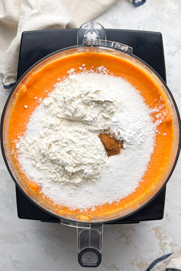 Flour, sugar, and cinnamon sit on top of the carrot mixture.