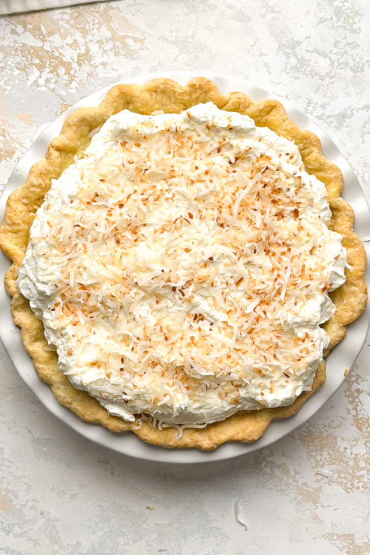 A finished coconut cream pie is shown from above.