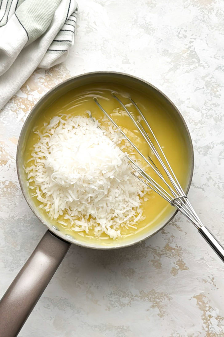 Shredded coconut is stirred into the pie filling.