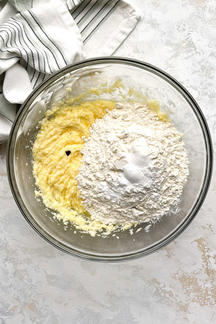 Dry ingredients added to wet ingredients for lemon crinkle cookies.