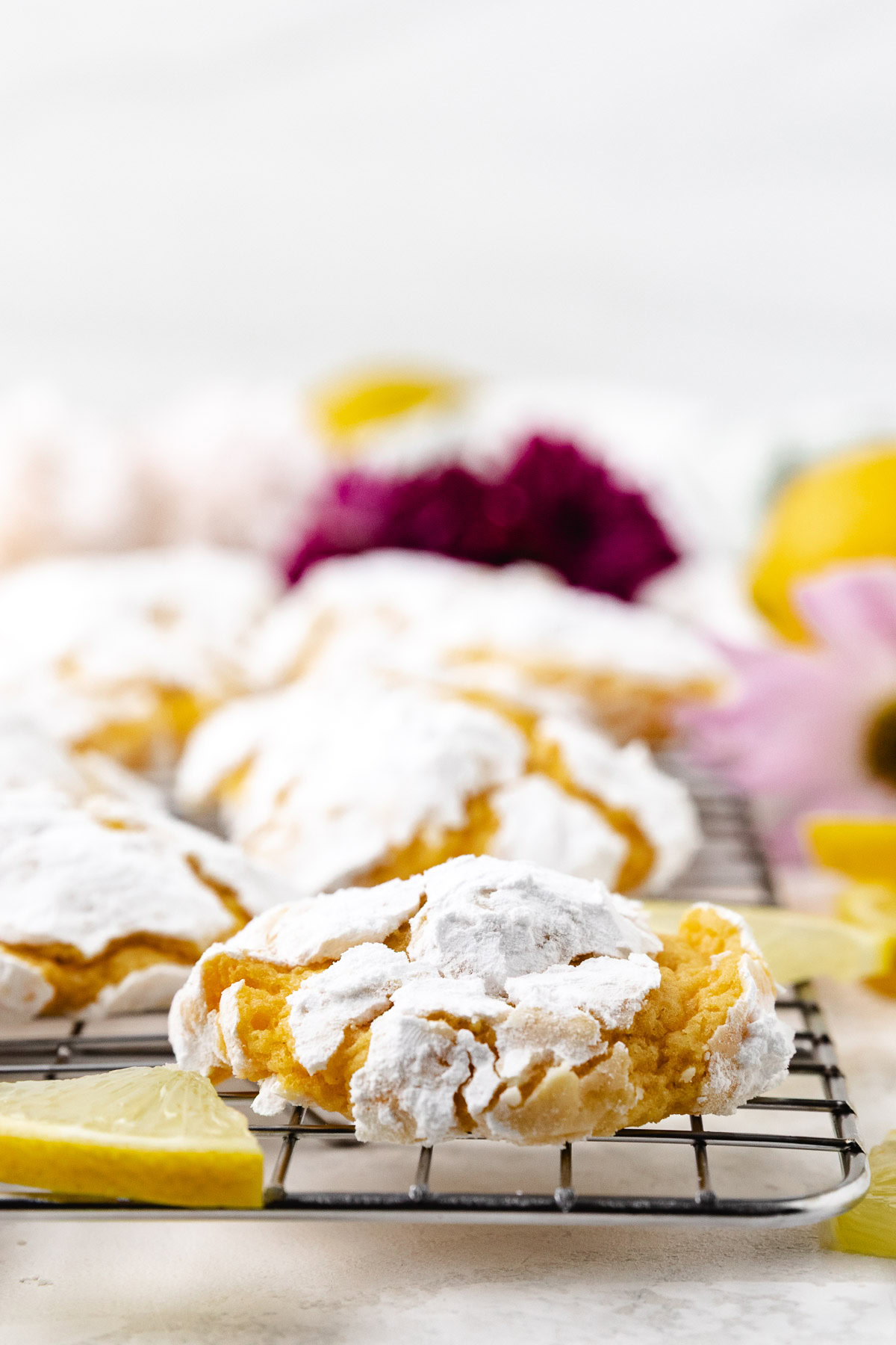 Crinkle cookie with powdered sugar on a cooling rack.
