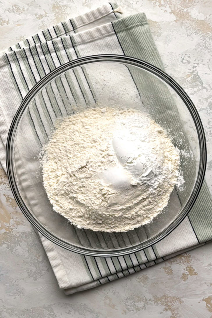 Flour, baking powder, and salt in a bowl.