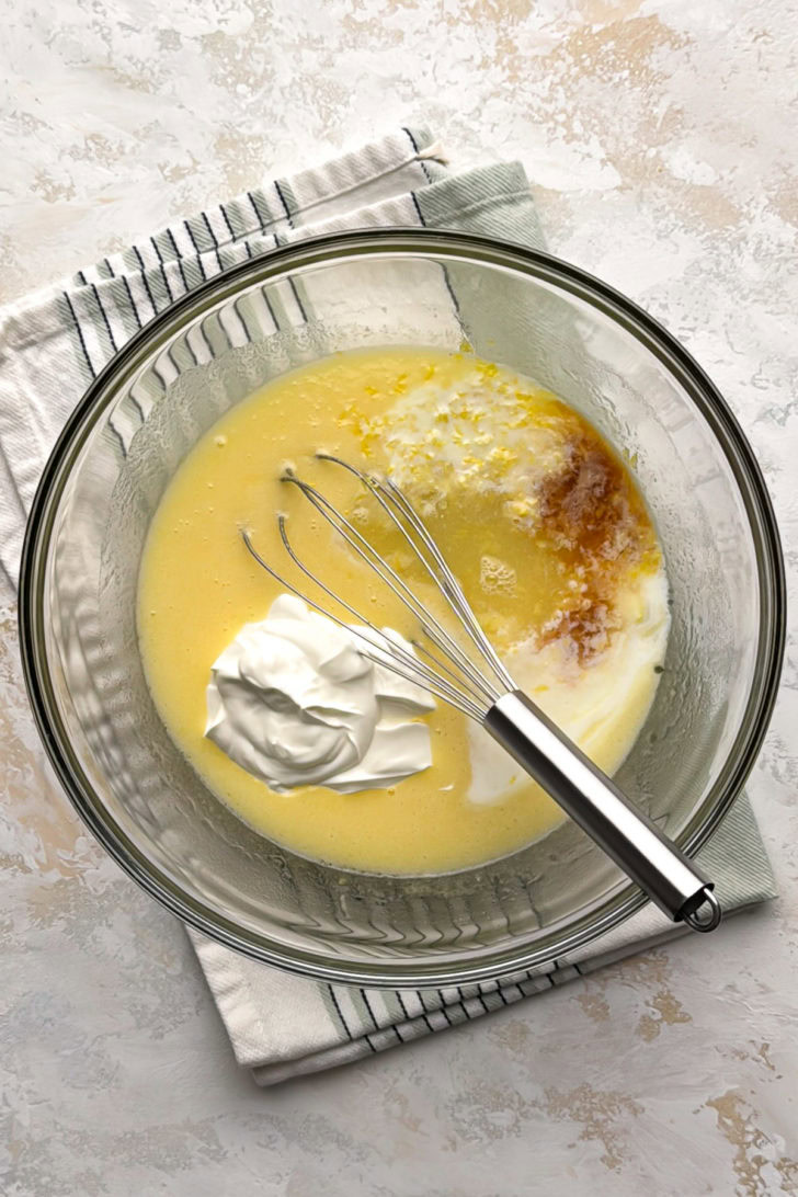 Wet ingredients for lemon quick bread in a bowl.
