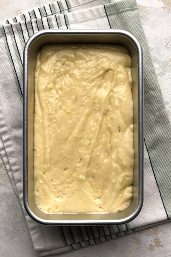 Lemon quick bread batter in a loaf pan.