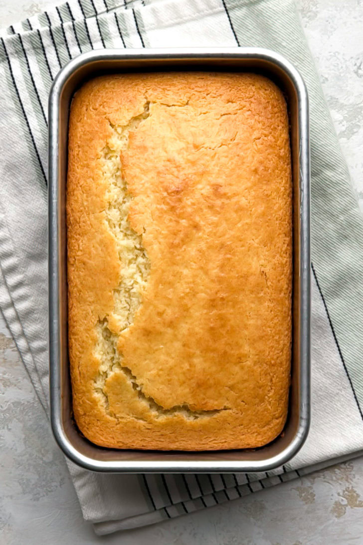 Baked lemon quick bread in a loaf pan.