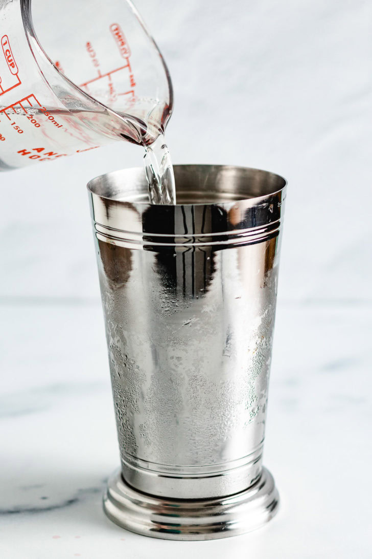 Coconut rum being added to a shaker cup.