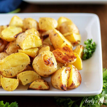 Close up view of a plate of oven baked ranch potatoes.
