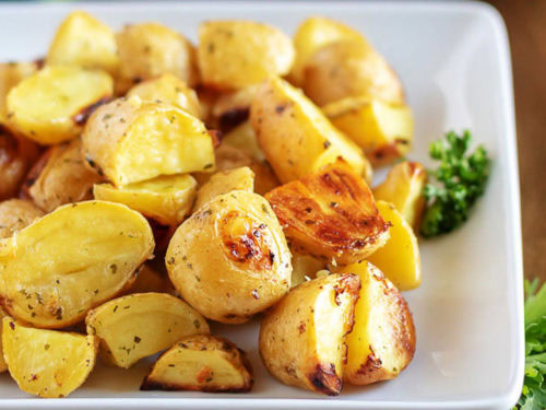Close up view of a plate of oven baked ranch potatoes.