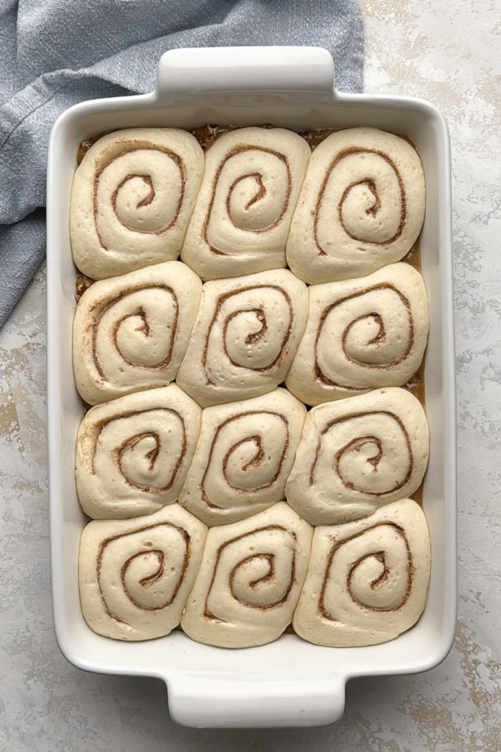 Rhodes cinnamon rolls after rising in the pan, puffy and ready to bake.