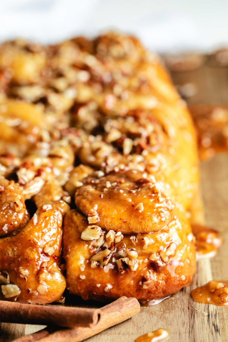 Sticky buns with Rhodes cinnamon rolls baked until golden and glossy, topped with chopped pecans.