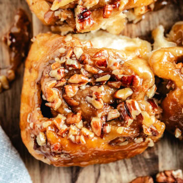 Easy pecan sticky buns with a buttery brown sugar caramel topping, made with Rhodes cinnamon rolls.
