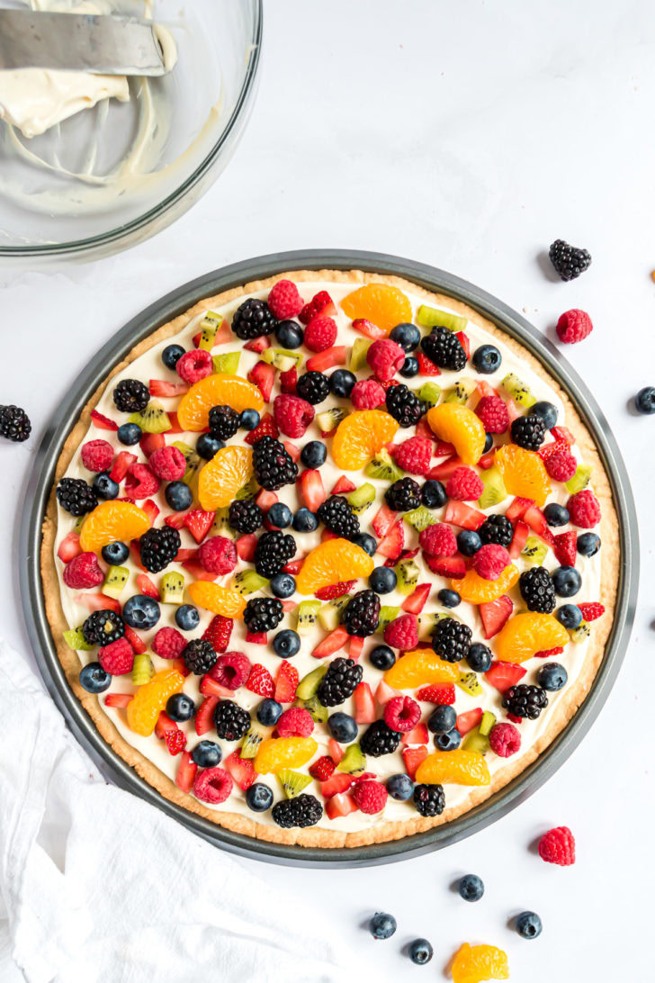 Fruit pizza topped with fresh fruit.