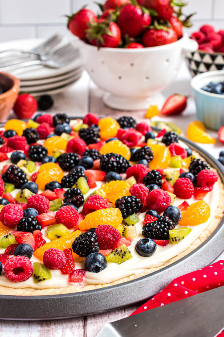 Fruit pizza on dessert table.