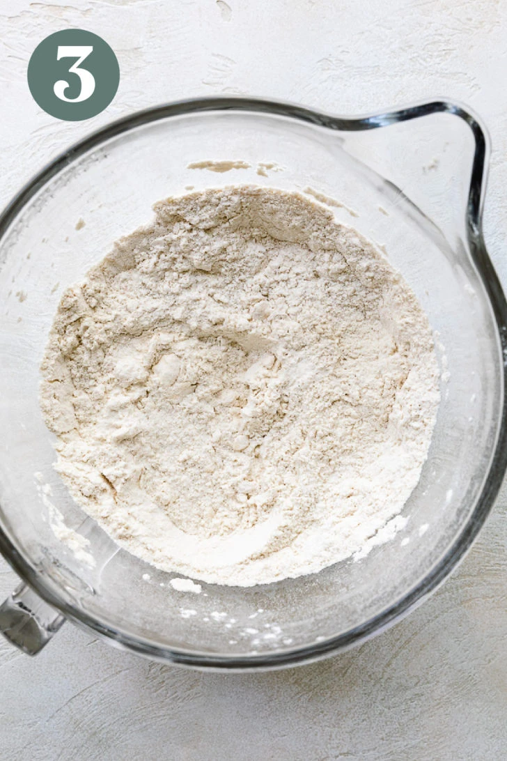 Butter cut into flour mixture for brioche rolls.