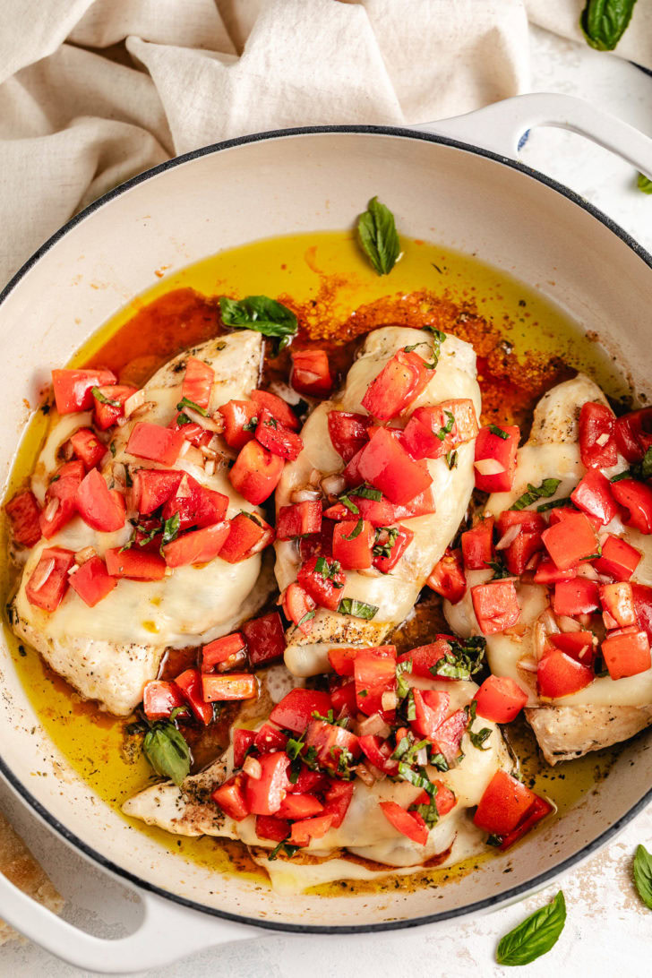 Pan filled with fresh tomato bruschetta chicken and basil.