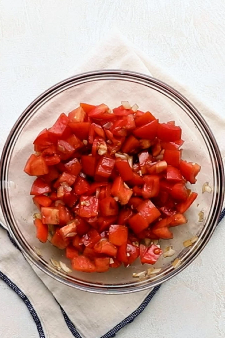 Tomato bruschetta in a glass bowl on a linen.